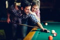 Young couple playing snooker together in bar Royalty Free Stock Photo