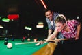 Young couple playing snooker together in bar Royalty Free Stock Photo