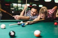 Young couple playing snooker together in bar Royalty Free Stock Photo