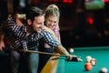 Young couple playing snooker together in bar Royalty Free Stock Photo