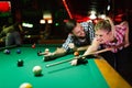 Young couple playing snooker together in bar Royalty Free Stock Photo