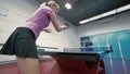 Young couple playing the table tennis at the court