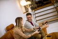 Young couple playing video games at home, sitting on sofa and enjoying themselves Royalty Free Stock Photo