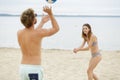Young couple playing volley ball on beach Royalty Free Stock Photo