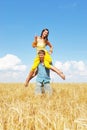 Young couple playing on wheat sunny field Royalty Free Stock Photo