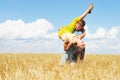 Young couple playing on wheat sunny field Royalty Free Stock Photo