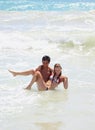 Young couple plays in the surf Royalty Free Stock Photo