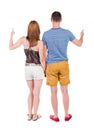 Young couple pointing at wal Back view Royalty Free Stock Photo