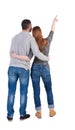 Young couple pointing at wal Back view (woman and man). Royalty Free Stock Photo