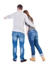 Young couple pointing at wal Back view (woman and man). . Royalty Free Stock Photo