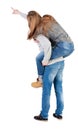 Young couple pointing at wal Back view (woman and man). Royalty Free Stock Photo