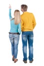 Young couple pointing at wal Back view (woman and man). Royalty Free Stock Photo