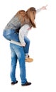 Young couple pointing at wal Back view (woman and man). Royalty Free Stock Photo