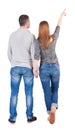 Young couple pointing at wall. Back view (woman and man). Royalty Free Stock Photo