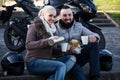 Young couple posing near motor bike Royalty Free Stock Photo