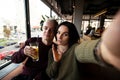 Young couple posing for selfie in public place. Attractive brunette woman and good looking blond man take photo in a Royalty Free Stock Photo