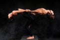 Acroyoga. Young couple practicing acro yoga on mat in studio together. Couple yoga. Partner yoga. Black and white photo.