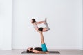 young couple Couple practicing acro yoga in white studio or gym. Healthy lifestyle