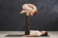 Young couple practicing acroyoga on mat together Royalty Free Stock Photo