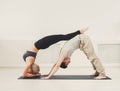 Young couple practicing acroyoga on mat together Royalty Free Stock Photo