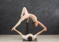 Young couple practicing acroyoga on mat together Royalty Free Stock Photo