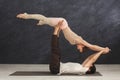 Young couple practicing acroyoga on mat together Royalty Free Stock Photo