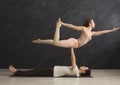 Young couple practicing acroyoga on mat together Royalty Free Stock Photo