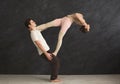 Young couple practicing acroyoga on mat together