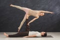 Young couple practicing acroyoga on mat together Royalty Free Stock Photo