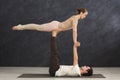 Young couple practicing acroyoga on mat together Royalty Free Stock Photo