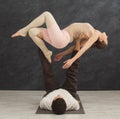 Young couple practicing acroyoga on mat together Royalty Free Stock Photo