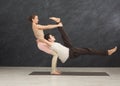 Young couple practicing acroyoga on mat together Royalty Free Stock Photo