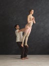 Young couple practicing acroyoga on mat together