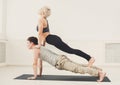 Young couple practicing acroyoga on mat together Royalty Free Stock Photo