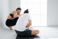 Young couple practicing yoga in a white room Royalty Free Stock Photo