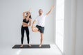 Young couple practicing yoga in a white room Royalty Free Stock Photo