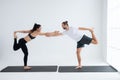 Young couple practicing yoga in a white room Royalty Free Stock Photo