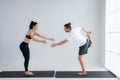 Young couple practicing yoga in a white room Royalty Free Stock Photo