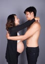 Young couple: pregnant mother and happy father on gray backgroun Royalty Free Stock Photo