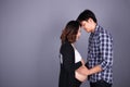 Young couple: pregnant mother and happy father on gray backgroun Royalty Free Stock Photo