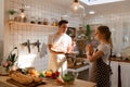 Young couple prepares cooking a breakfast in kitchen Royalty Free Stock Photo