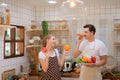 Young couple prepares cooking a breakfast in kitchen Royalty Free Stock Photo