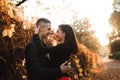 Young couple of pretty girl and man walk outdoors in park