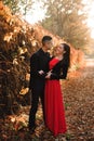 Young couple of pretty girl and man walk outdoors in park