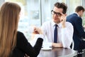 Young couple of professionals chatting during a coffeebreak Royalty Free Stock Photo