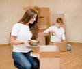 Young couple puts things in cardboard boxes for moving into a new house