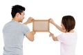 Young couple putting up picture frame Royalty Free Stock Photo