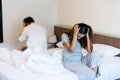 Young couple in quarrel sitting on bed at home. Upset lovers consider break up. Relationship breakdown  family relations  problems Royalty Free Stock Photo