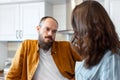 Young couple after quarreling fight in kitchen home interior. Woman and man had scandal argue quarrel. Girlfriend look Royalty Free Stock Photo