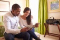Young couple read a guide brochure together in a hotel room Royalty Free Stock Photo